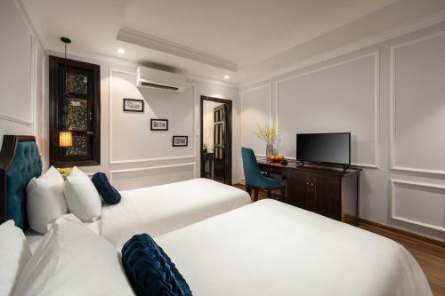 En eller flere senge i et værelse på Maya Boutique Hotel & Spa