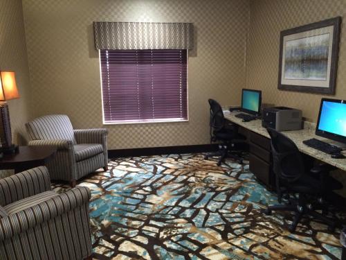 an office with two desks and two computers in a room at Holiday Inn Express Hotel & Suites Council Bluffs - Convention Center Area by IHG in Council Bluffs