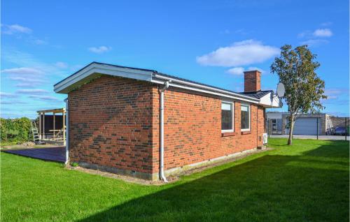 a red brick house with a grass yard at Gorgeous Home In Egå With Wifi in Egå