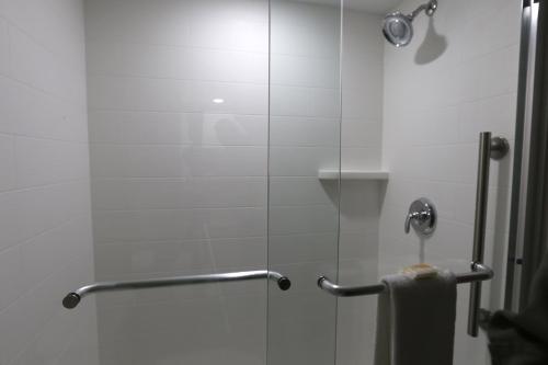 a shower with a glass door with a towel at Holiday Inn Express - Biloxi - Beach Blvd by IHG in Biloxi