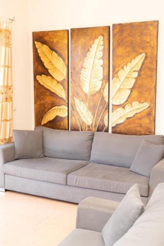 a living room with a couch in front of a painting at Astra Villas in Skala Kefalonias