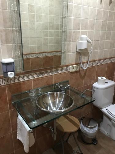 a bathroom with a sink and a toilet at Hotel Rural El Alberche in Burgohondo