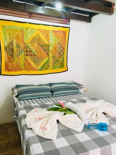a bedroom with a bed with towels on it at Casas Coloniais in Morro de São Paulo