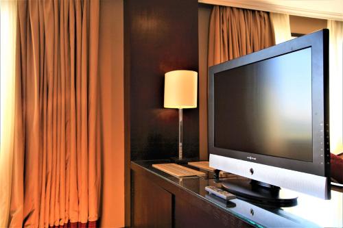 a television on a table in a hotel room at Jaz Monarch Nile Cruise - Every Monday from Luxor for 07 & 04 Nights - Every Friday From Aswan for 03 Nights in Luxor