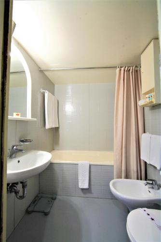 a bathroom with a sink and a toilet and a mirror at Jaz Monarch Nile Cruise - Every Monday from Luxor for 07 & 04 Nights - Every Friday From Aswan for 03 Nights in Luxor