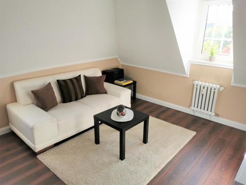 a living room with a white couch and a table at Spilburg Apartments in Wetzlar