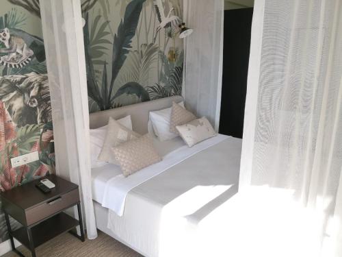 a white bed with pillows on it in a room at Zigo's Hotel in Mugla