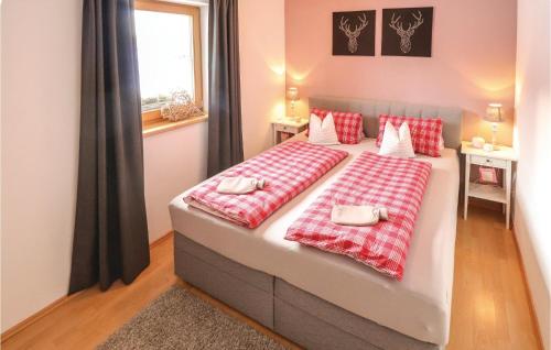 a bedroom with a large bed with red and white pillows at Beautiful Apartment In Alpbach With 1 Bedrooms And Wifi in Alpbach