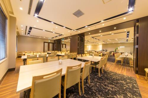 a dining room with tables and chairs at Hotel IL Cuore Namba in Osaka