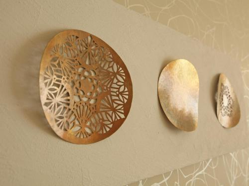 a wooden plate with a design on a wall at Hotel Nikko Kanazawa in Kanazawa