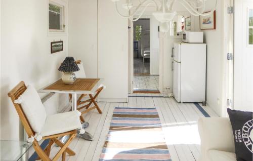 a kitchen with a table and a refrigerator at Lovely Home In Trosa With Wifi in Trosa