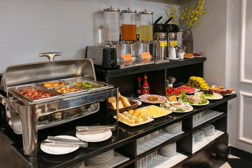 a buffet with many different types of food on plates at Maya Boutique Hotel & Spa in Hanoi