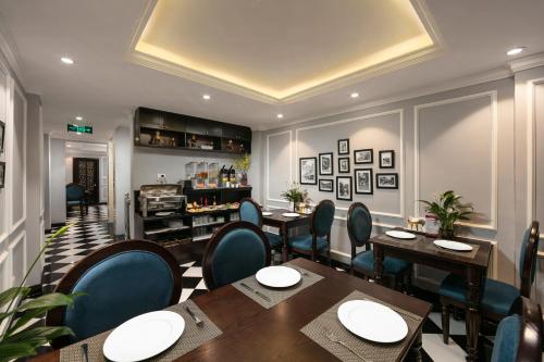 a restaurant with tables and chairs and a bar at Maya Boutique Hotel & Spa in Hanoi