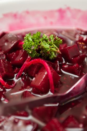 a bowl of red beets with a green plant on top at Premier Hotel Cape Town in Cape Town