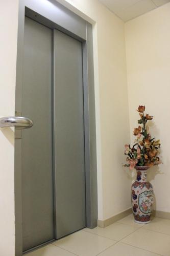 a glass door in a room with a vase at Ca La Maria in Tordera
