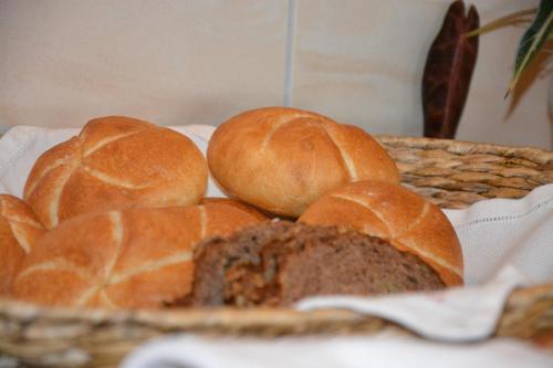 a basket filled with bread and buns on a table at Gästehaus Wöll in Alpbach