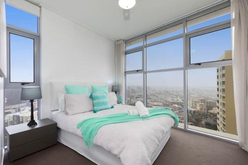 a bedroom with a bed with a large window at SK1 - 2 level 2 Bedroom Skyline SkyHome in Brisbane