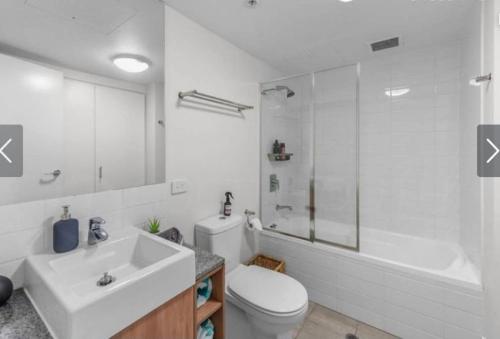 a bathroom with a sink and a toilet and a tub at AU1 - Aurora Skyscraper CBD For Business or Pleasure in Brisbane
