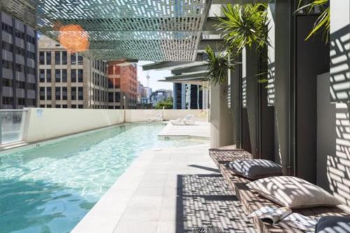 a swimming pool on the roof of a building at AU1 - Aurora Skyscraper CBD For Business or Pleasure in Brisbane