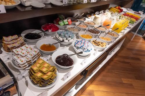Una línea de buffet con muchos tipos diferentes de comida. en Yrigoyen 111 Hotel, en Córdoba