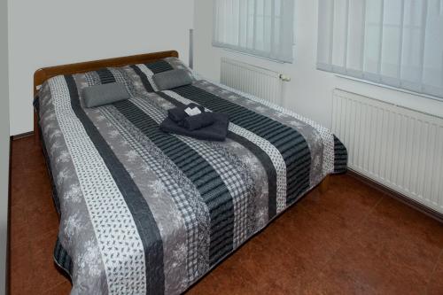 a bed with a hat on it in a room at Čerti Apartmány in Liberec