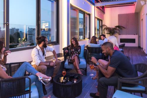 a group of people sitting in chairs in a room at iQ Hotel Milano in Milan