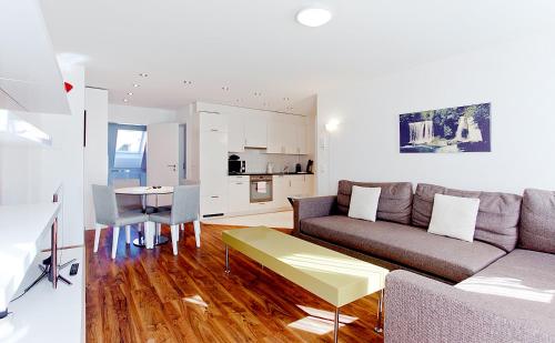 a living room with a couch and a table at Premium Apartments by Livingdowntown in Zürich
