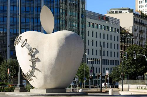 an apple statue in the middle of a city at iQ Hotel Milano in Milan