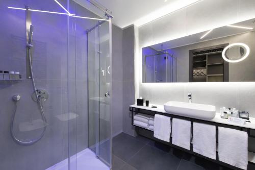 a bathroom with a shower and a sink and a mirror at iQ Hotel Milano in Milan