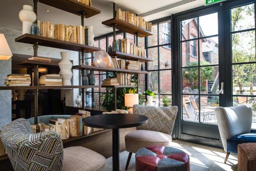 a room with a table and chairs and windows at The Swan, Streatley, Berkshire in Streatley