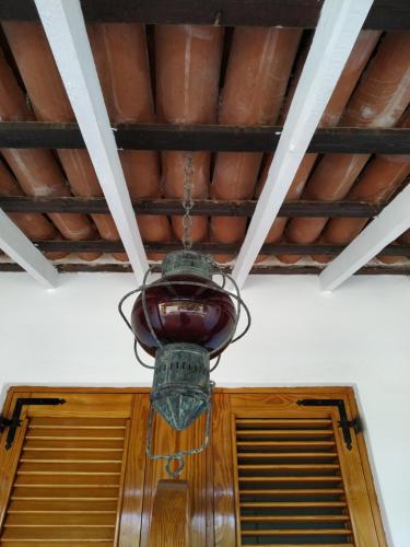 a chandelier hanging from a ceiling over a door at La Casa al Mare Vulcano in Vulcano