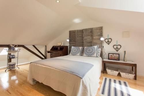 a bedroom with a large bed and a wooden floor at Lisbon Avenida Apartment in Lisbon