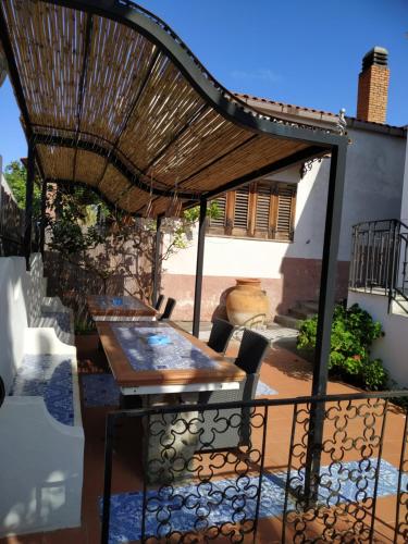 a patio with a table and an umbrella at La Casa al Mare Vulcano in Vulcano