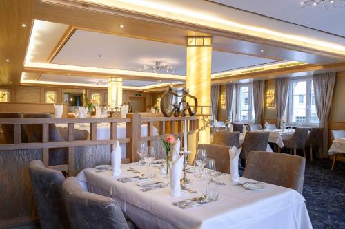 a dining room with a table with white table cloth at Ringhotel Krone in Friedrichshafen