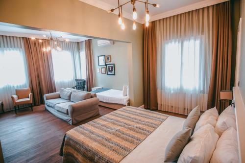 a large living room with a couch and a living room with at Rodosto Hotel in Tekirdağ