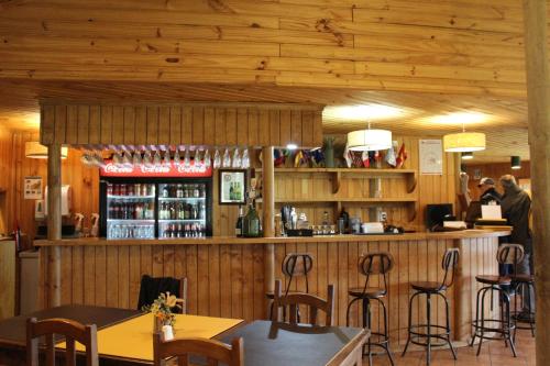 a bar in a restaurant with tables and chairs at Hotel del Paine in Torres del Paine