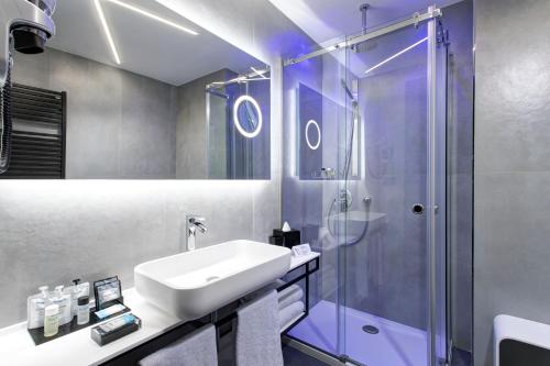 a bathroom with a sink and a shower at iQ Hotel Milano in Milan