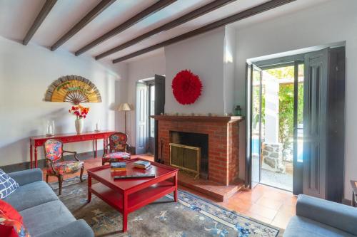 a living room with a couch and a fireplace at Santo António's Guesthouse in Cascais