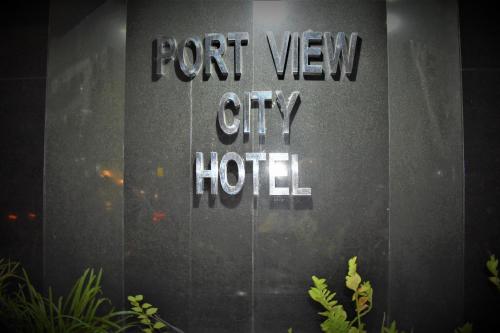 a sign for a hotel on the side of a building at Port View City Hotel in Colombo