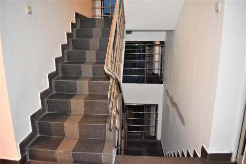 a staircase in a house with wooden railings at Port View City Hotel in Colombo