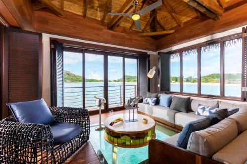 
a living room filled with furniture and a window at Royalton Antigua, An Autograph Collection All-Inclusive Resort & Casino in Five Islands Village
