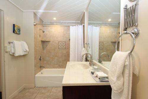 un baño con lavabo y bañera en Forest Lodge, en Carmel