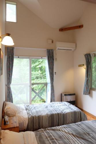 En eller flere senger på et rom på Garden Villa Minamiaso