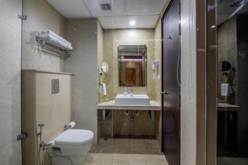 a bathroom with a toilet and a sink at Snow Valley Resorts Shimla in Shimla