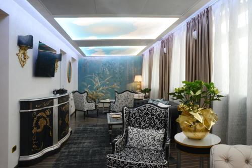 a living room with a couch and chairs and a table at Vip's Motel Luxury Accommodation & Spa in Lonato del Garda