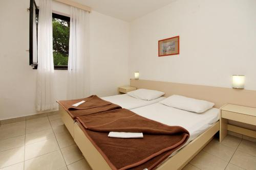 A bed or beds in a room at Apartments Savudrija Plava Laguna