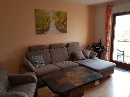 a living room with a couch and a coffee table at Gästewohnungen Hennig in Markkleeberg