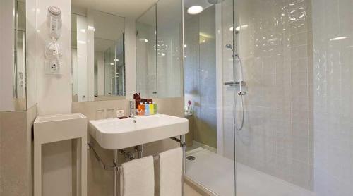 
a bathroom with a sink, toilet and bathtub at Axel Hotel Barcelona & Urban Spa- Adults Only in Barcelona
