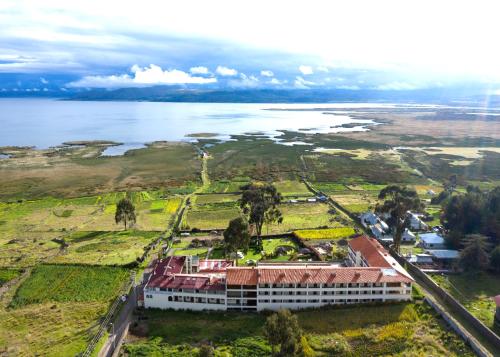 an aerial view of a resort next to the water at Taypikala Lago in Puno
