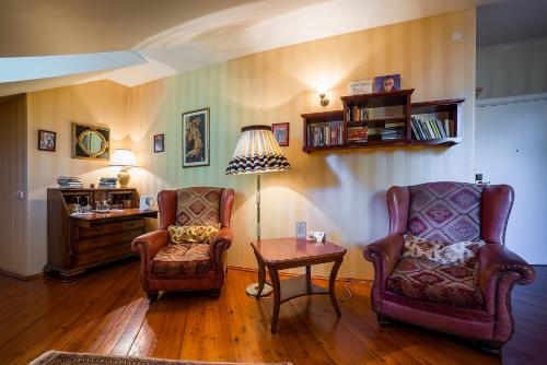a living room with two chairs and a table at Shakespeare Boutique Hotel in Vilnius